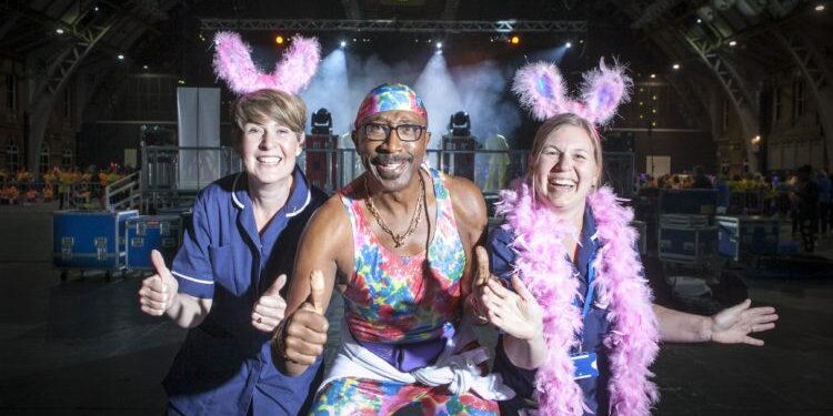 FREE TO USE PICTURE BY CHRIS BULL FOR ST ANN'S HOSPICE  19/6/15 - 20/6/15
St Ann's Hospice Midnight Walk through Manchester on Friday night.
St Ann's Little Hulton nurses Sarah McDonnell (left) and Kelly Keane with Mr Motivator.