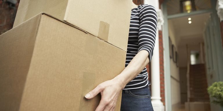 woman-carrying-brown-boxes-from-house-royalty-free-image-108353192-1553390570